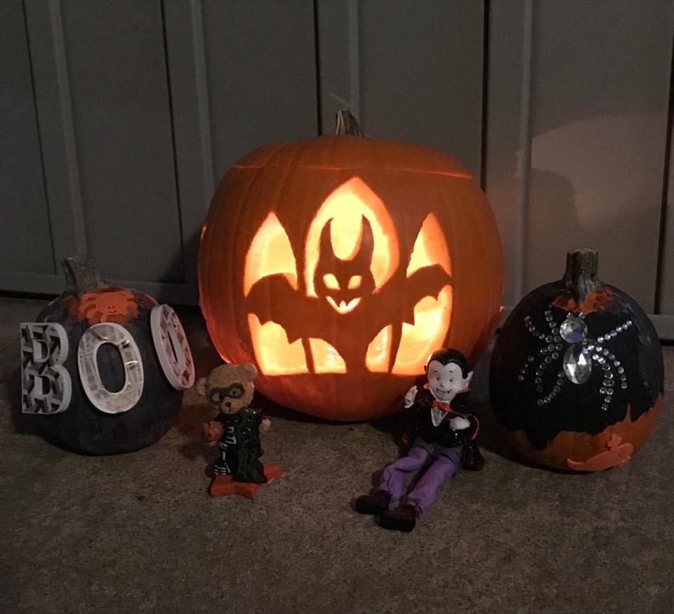 Two painted pumpkins made by my girls and my bat shaped carved pumpkin